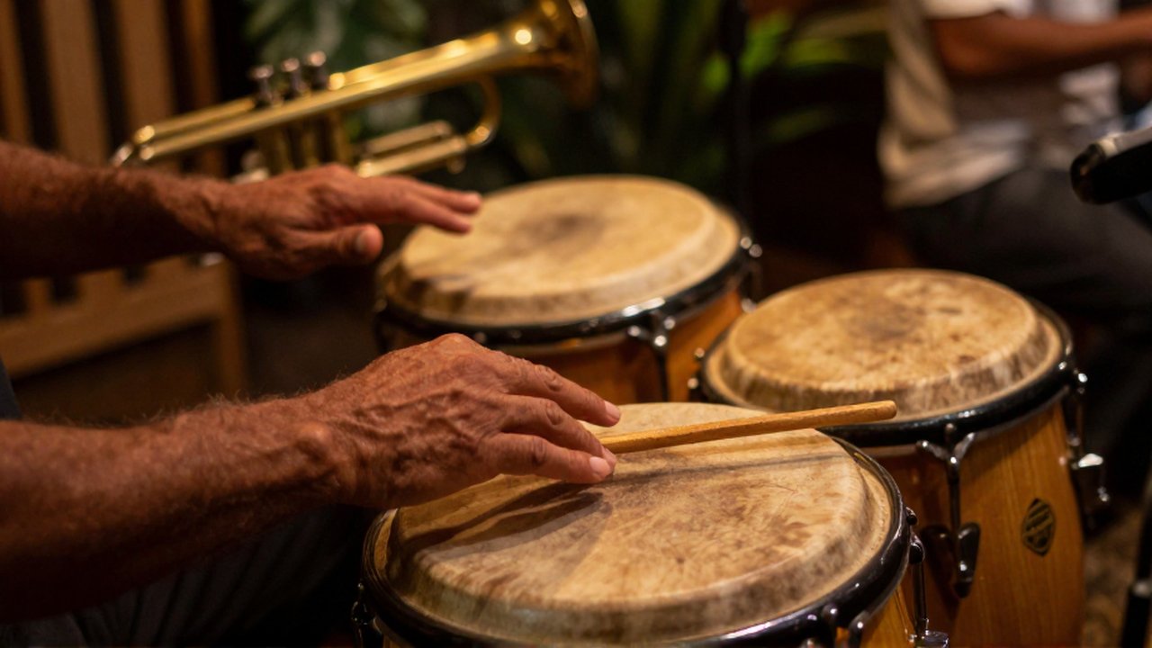 Hands of a percussionist playing wooden claves and a conga drum in a warm studio.